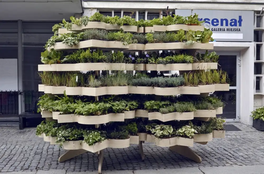 Front view of Green City Furniture filled with layered planting.
