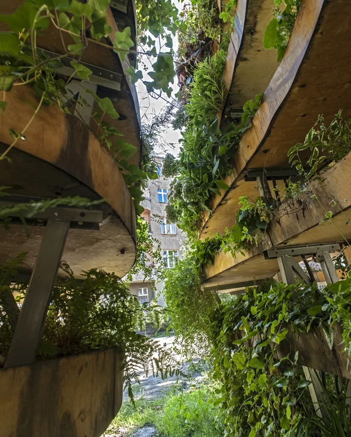 Visitors inside The Infinite Green planted structure.